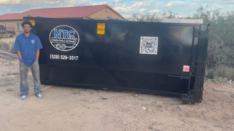 NTG Waste Removal Employee standing next to the side of a 20 yard roll-off dumpster in Vail AZ