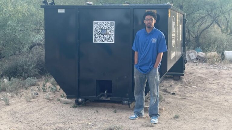 NTG Waste Removal Employee standing next to a 20 Yard roll-off dumpster