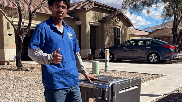 NTG Waste Removal Employee standing beside an old dish washer appliance